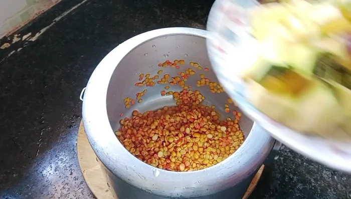 Prepare the sambar: Cook toor dal, gram, and optional urad dal with brinjal, pumpkin, turmeric, and salt until it whistles 2-3 times. Add tamarind pulp (soaked in hot water).