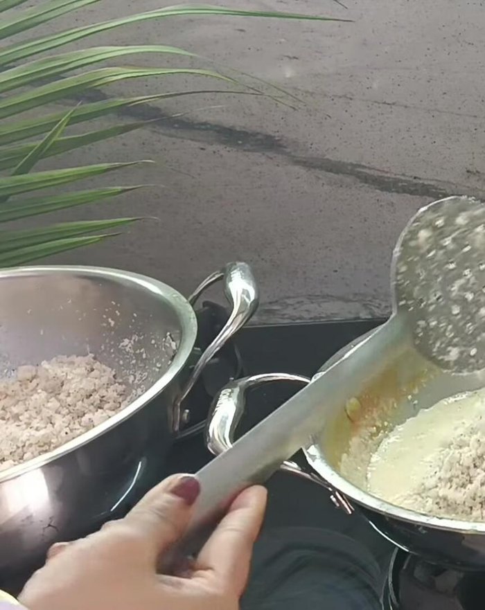 Combine and Cook: Add the roasted coconut to the mawa. Increase the heat and stir well until all the water evaporates and the mixture thickens.