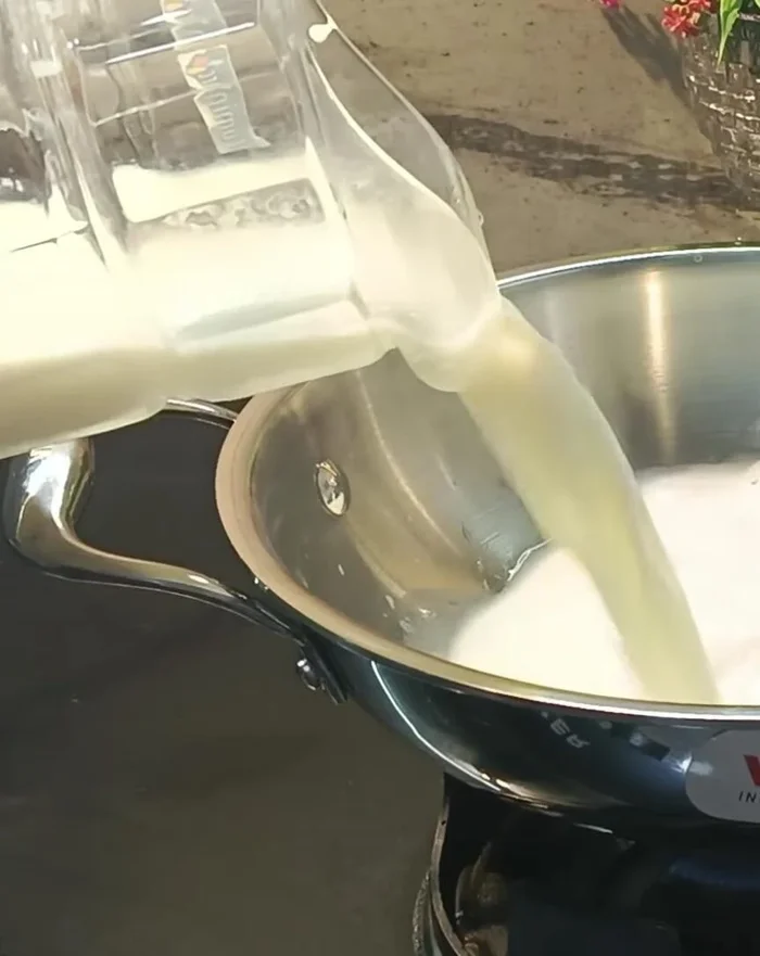 Make Mawa: In a heavy-bottomed pan, add 2-3 spoons of water, then add 1.25 liters of milk. Cook on high heat, stirring constantly until it boils. Reduce heat and continue stirring until it thickens and becomes grainy.