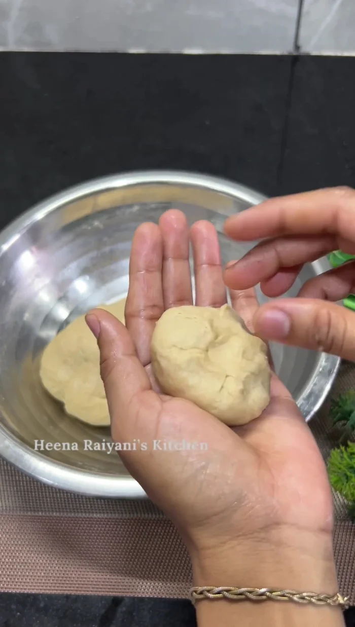 Shape the dough into buns. Place them on parchment paper-lined perforated steamer plates. (300.4)