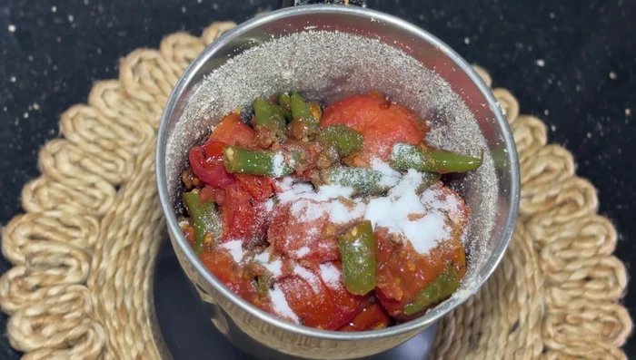 Add salt to taste. No need to add water; the tomatoes release their own. Add coriander if desired.