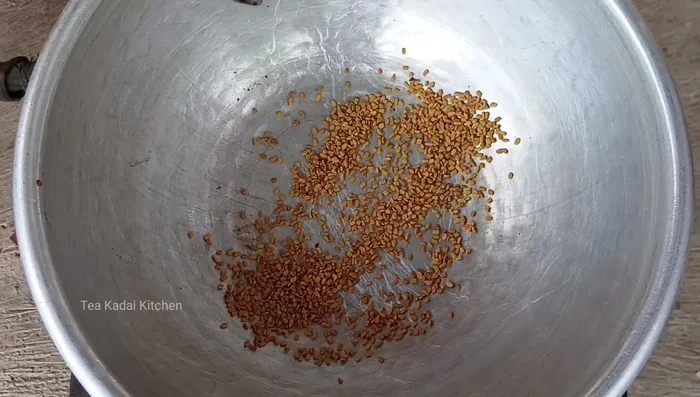 Separately, fry fenugreek (25g) until fragrant. Add red chilies (10) and fry for a minute. Add curry leaves and fry lightly.