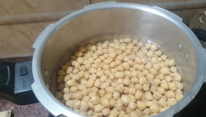 Cook the chickpeas: Add salt to soaked chickpeas and pressure cook for four whistles.