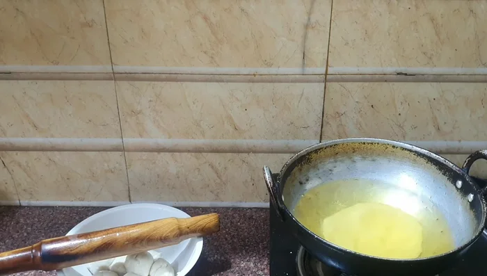 Fry the Puris: Fry the puris in hot oil until golden brown and puffy.