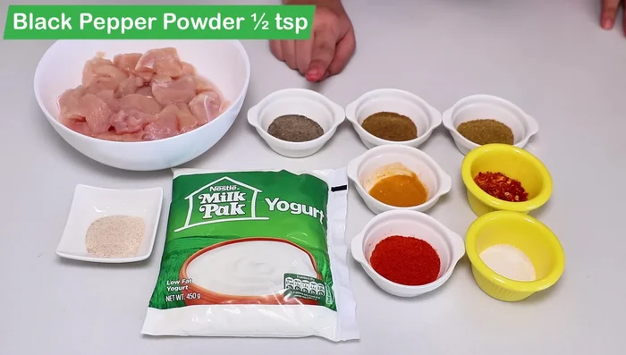 Marinate the chicken: In a bowl, combine chicken with yogurt, black pepper powder, cumin powder, coriander powder, turmeric powder, red chili powder, salt, garlic powder (or paste). Mix well.