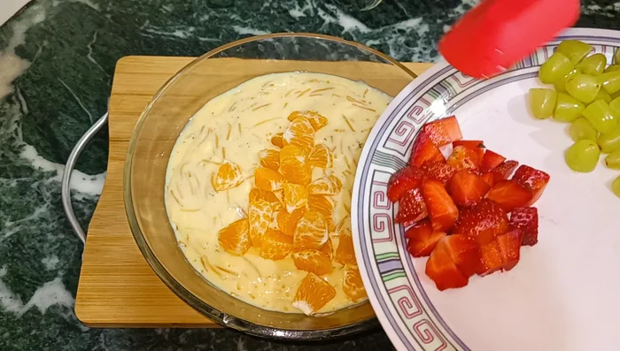 Add chopped fruits (orange, strawberries, grapes, pomegranate).