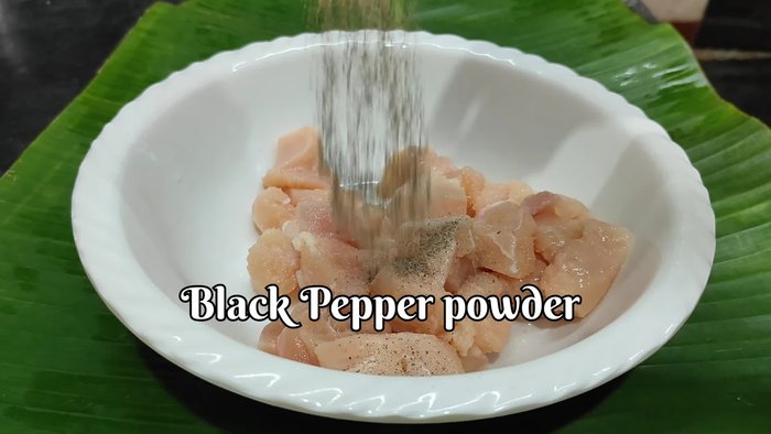 Marinate the chicken: In a bowl, combine chicken, salt, pepper, ginger, garlic, green chili, vinegar, soy sauce, maida, and egg white. Mix well and let it rest for 15 minutes.
