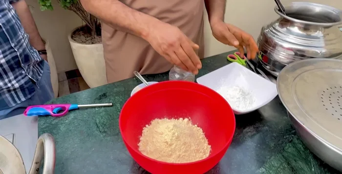 In a separate bowl, mix gram flour (some recipes add refined flour as well), corn flour, celery, garlic ginger paste (or powder), and water to create a smooth batter without lumps.