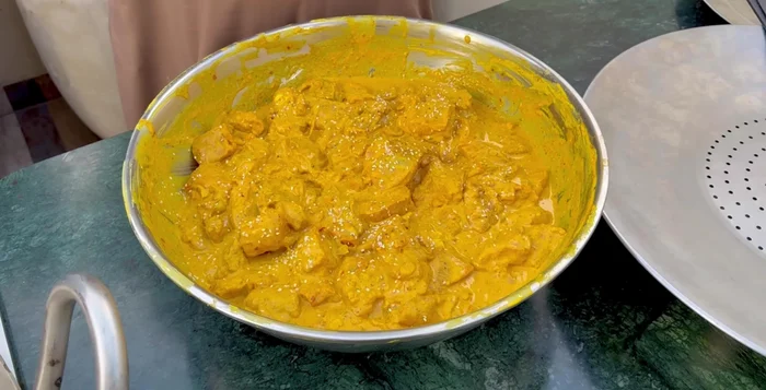 Carefully add the chicken pieces to the hot oil, ensuring not to overcrowd the pan. Fry for 10 minutes, stirring gently to prevent sticking and ensure even browning.