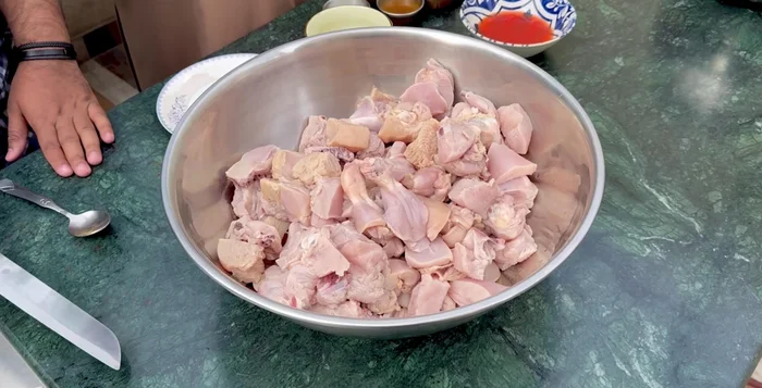 After half an hour, wash the chicken again and drain in a strainer.