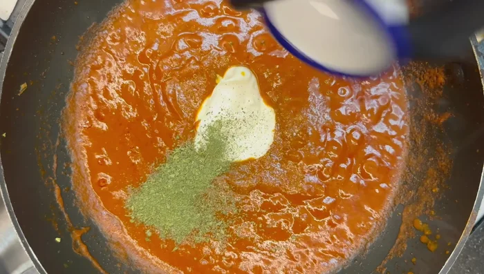 Add the cooked lamb, fresh tomatoes, and simmer gently for 5 minutes.