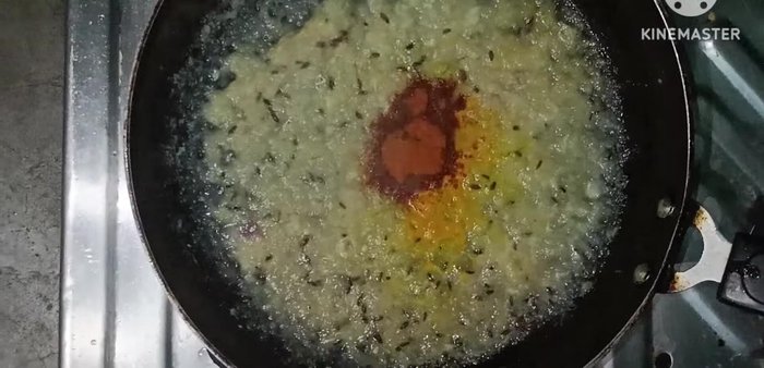 Add turmeric powder, red chili powder, green chilies (optional), and salt to taste.
