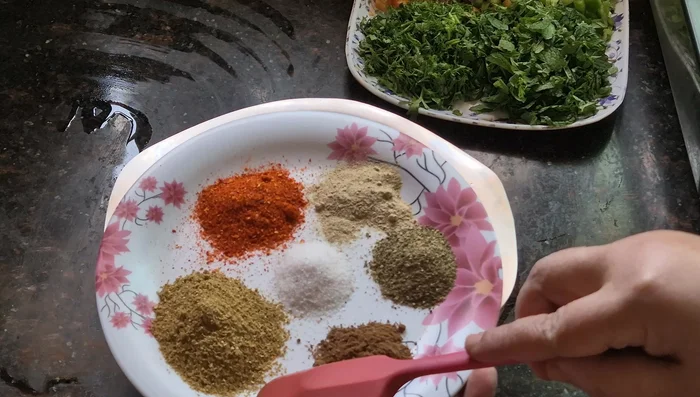 Add spices to the chicken: coriander powder, cumin powder, garam masala, black pepper, chaat masala, salt, and chili powder.