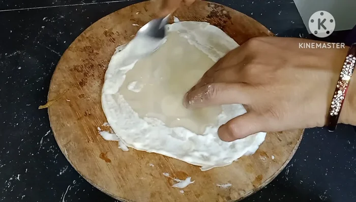 Assemble the spring rolls: Spread the flour paste on the cooked rotis. Place a portion of the beef mixture in the center, fold the sides, and roll tightly.