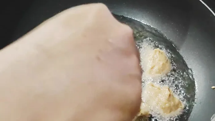 Drop spoonfuls of the batter into the hot oil, frying until golden brown on both sides. They should be fluffy.