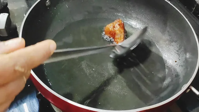 Remove the gulgule from the oil and drain on paper towels.