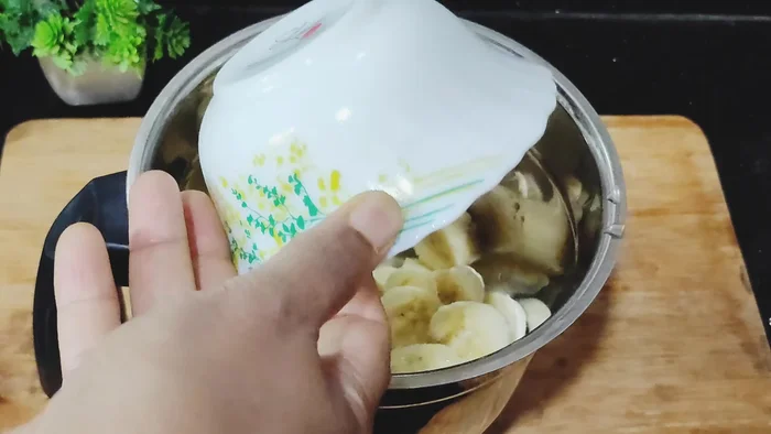 Blend two slightly ripe bananas, ½ cup jaggery powder, and ½ cup milk in a mixer until smooth.