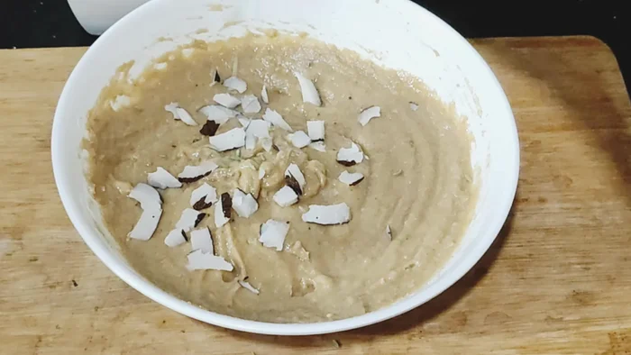 Stir in chopped dry coconut, 1 teaspoon fennel seeds (or cardamom powder), ¼ teaspoon baking soda, and a pinch of salt.