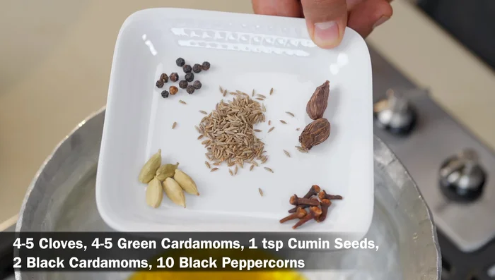 Add whole spices (cloves, cardamoms, cumin seeds, black peppercorns, cinnamon, mace, bay leaves) and crackle them (45.399).