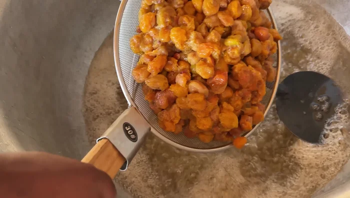 Add the soaked plums to the cooked sugar and cook until slightly hardened.