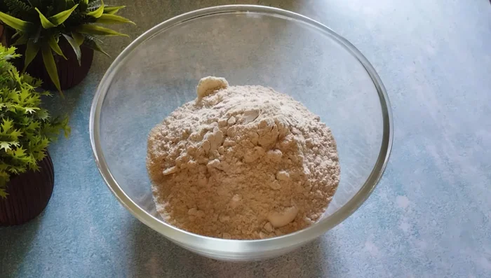 Transfer the ground mixture to a bowl. Add ½ cup wheat flour (or refined flour) and mix well.