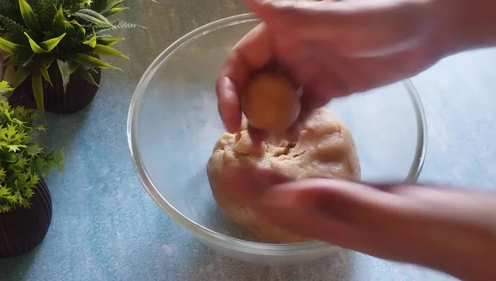 Make lemon-sized balls of dough, flatten slightly, and shape into round biscuits.
