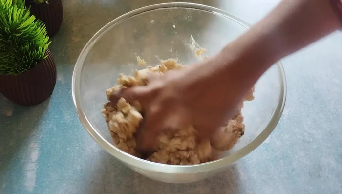 Gradually add water, kneading to form a firm, slightly hard dough.