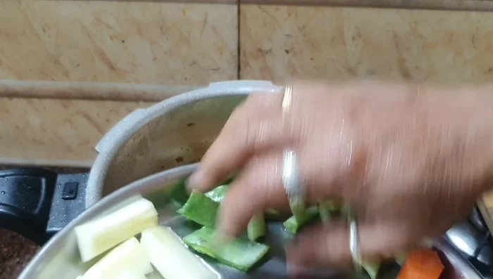 Add all chopped vegetables except mangoes and drumsticks. Sauté for a couple of minutes.