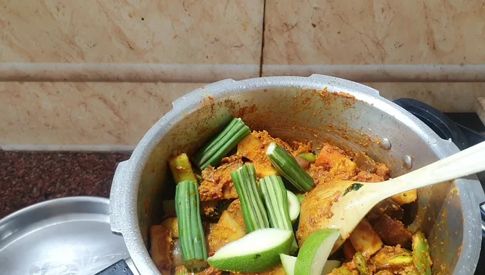 Add mangoes and drumsticks.