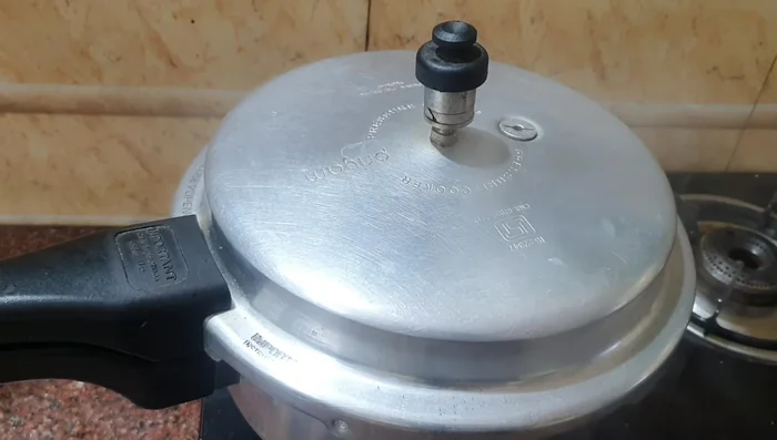 Add soaked rice and lentils. Cover and cook for 3 whistles.