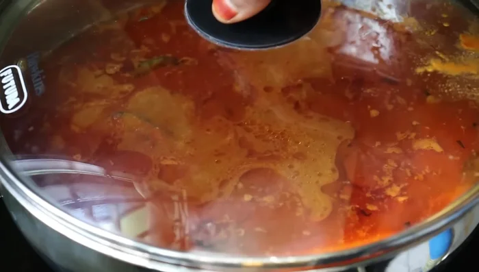 Add the fish pieces and coconut paste. Simmer until the fish is cooked.