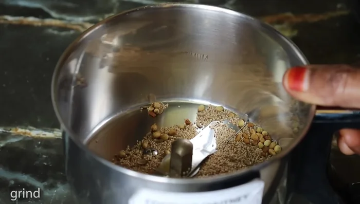 Grind coconut to a paste.