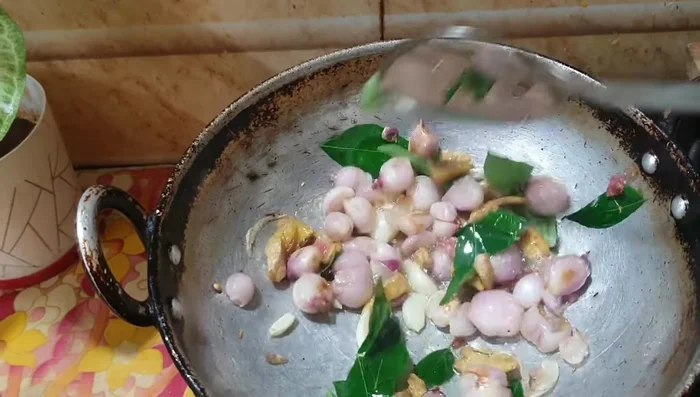 Add 2 bunches of curry leaves and fry until well cooked.