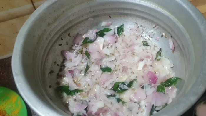 Grind together the chili, a small onion, and ginger-garlic paste into a paste.