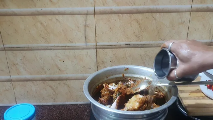 Add water as needed to create the gravy consistency. Cover and cook on medium flame for about 10 minutes, or until the crab is cooked through.