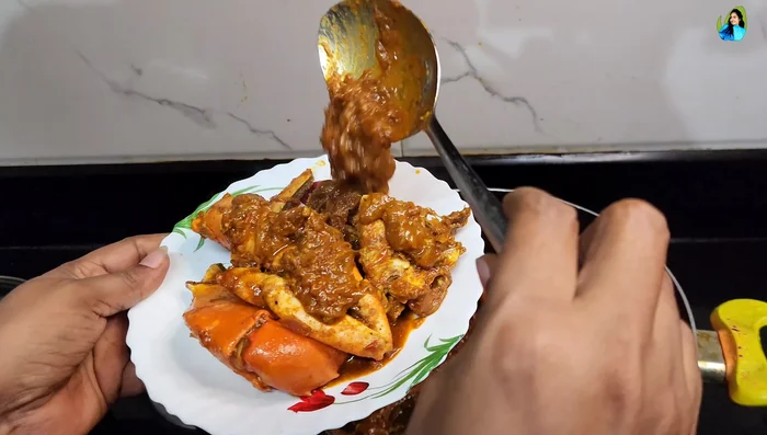 Layer the cooked rice and crab masala in a pot, add some gravy, and top with ghee.
