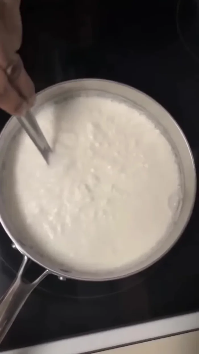 Add 1 cup of curd to the boiling milk.
