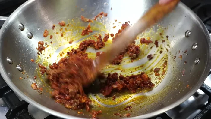 Add the blended tomato-ginger-garlic puree. Stir and cover, cook on medium heat for 5 minutes.