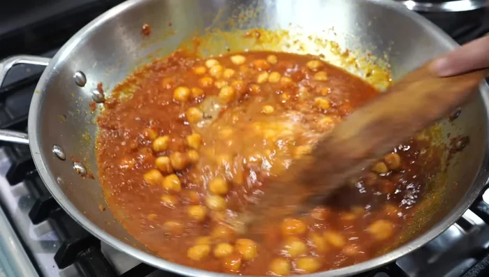 Add the chickpea paste and black pepper powder to the gravy. Cover and simmer on low heat for 15 minutes, stirring occasionally.
