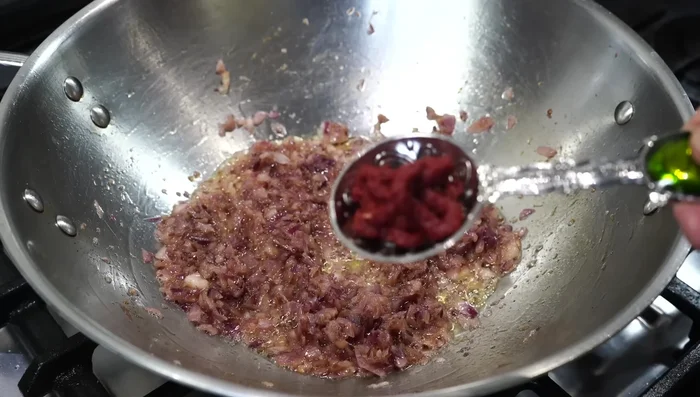 Add tomato paste and fry for a minute on medium-low heat.
