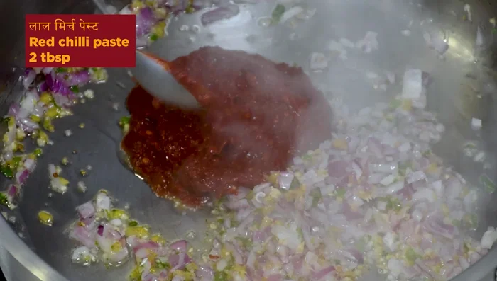 Add red chili paste, red chili sauce, soy sauce, vinegar, asafoetida, black salt, and salt. Stir in Schezwan chutney, Hindustani masala, coriander powder, black pepper, and red chili powder.