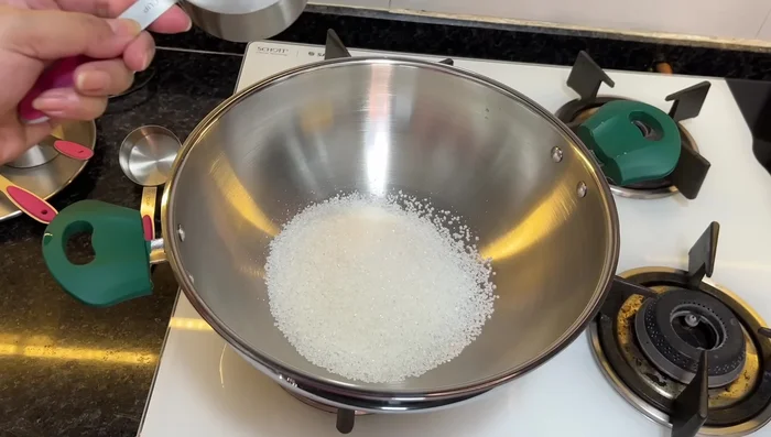 Prepare the syrup: In a separate pan, combine sugar and water. Cook until it reaches one-string consistency (last drop resists and falls from the spoon).