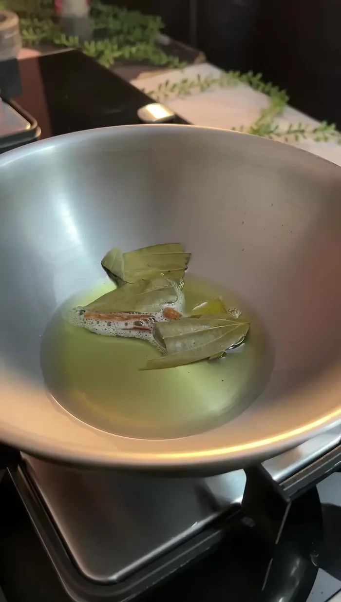 In the remaining oil, sauté cinnamon, bay leaves, and finely chopped onions until cooked.