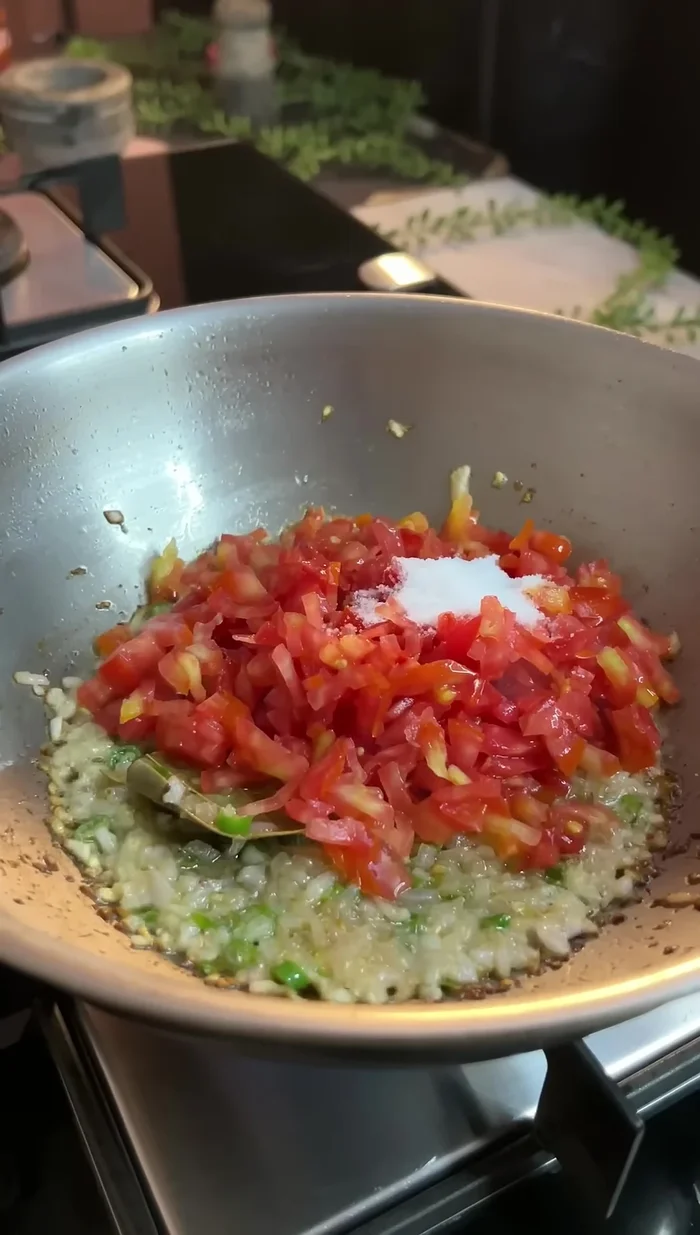 Add tomatoes and salt, cook until tomatoes are soft.