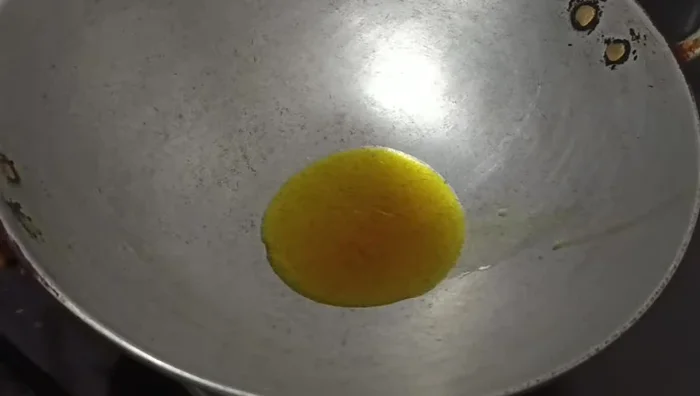 Heat 1 spoon of oil in a pan. Add a green chili.