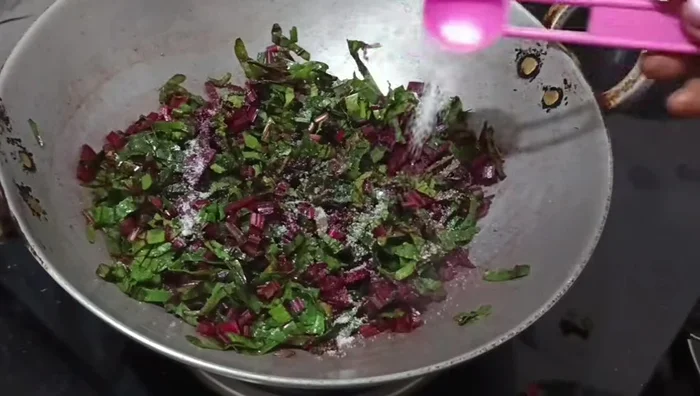 Mix well, add salt, and cover the pan for a while to let the water dry.