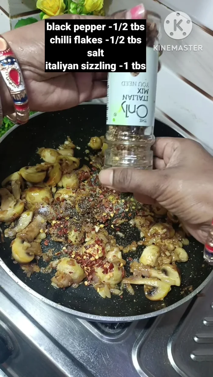 Season with black pepper powder, chili flakes, salt, and Italian seasoning (or mixed herbs/oregano). Fry for another 2-3 minutes until well coated.