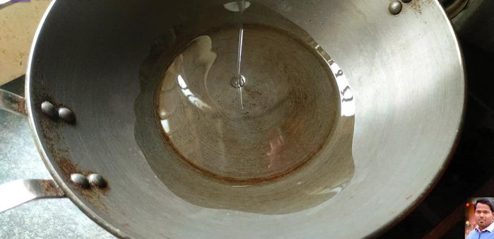 Heat 50-60 grams of cooking oil in a pan. Add cumin seeds and a pinch of salt.