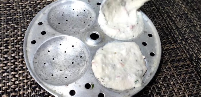 Fill the greased idli plates with the batter.