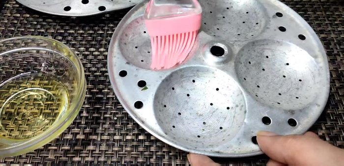 Grease the idli plates.